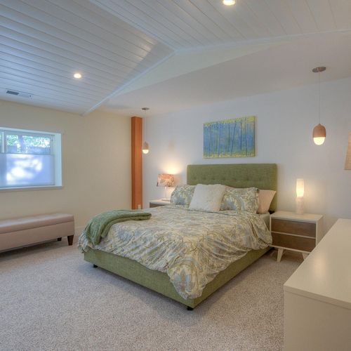 Second guest bedroom with a queen bed and dresser.