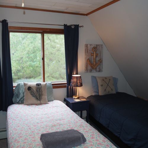 Bedroom #4 (second floor):  features 3 twin-size beds, nightstands with lamps, ceiling fan, closet, dresser, chair, and its own private television.