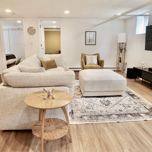 Comfortable carpeting and a cozy sectional in the basement living room.