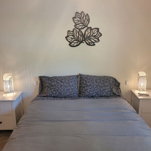 Bedroom #1:  features a sleep number adjustable queen-size bed, closet, ceiling fan, nightstands, and lamps.