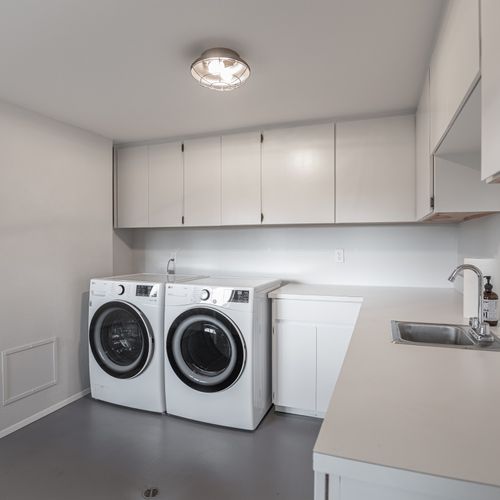 Large laundry room with new LG washer and dryer.  Laundry soap and stain remover are provided.