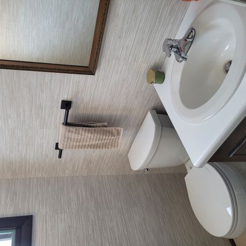 Bathroom #2:  cute little half-bathroom with toilet, sink, vanity, and mirror located near the rear door out to the deck.