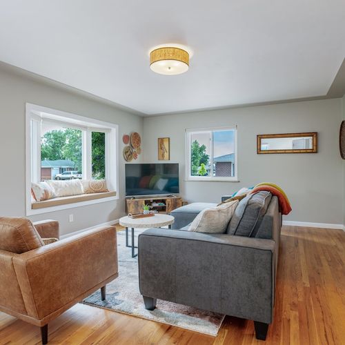 - stylish living room with plush seating, a smart tv, and thoughtful boho chic touches
- unwind on the bay window bench, perfect for reading or soaking in the view
- hardwood floors and soft lighting set the stage for movie nights or cozy evenings in