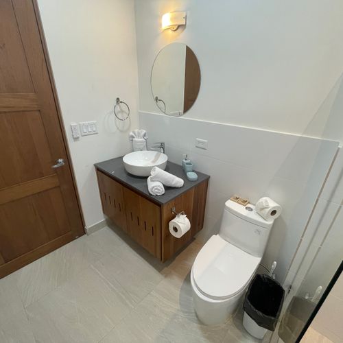 Gorgeous full bathroom at the hall with ceiling fan.