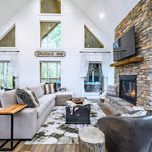 The living room with a floor to ceiling fireplace and Queen sofa sleeper.