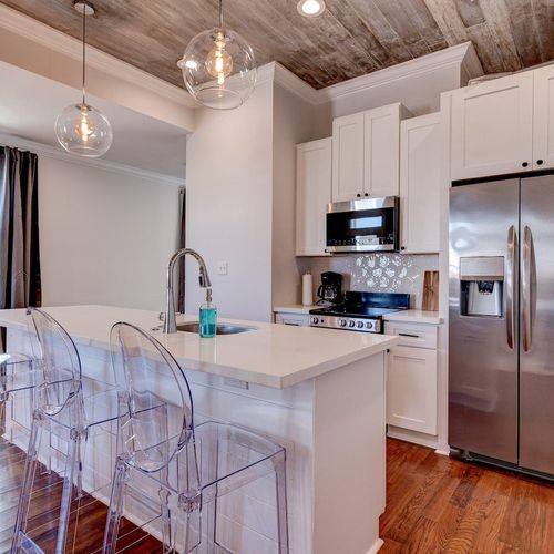 Sleek kitchen w/ bar seating — perfect for morning coffee or casual meals.