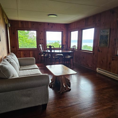 Living room:  the dining room with the couch and  table with a view of crystal lake