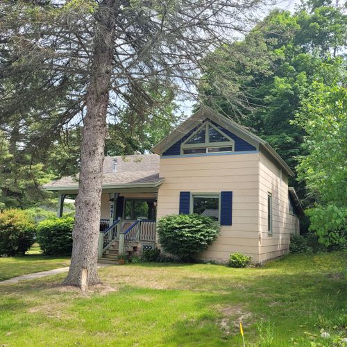 Exterior:  another view of the house, highlighting the huge spruce tree that is in the front yard.