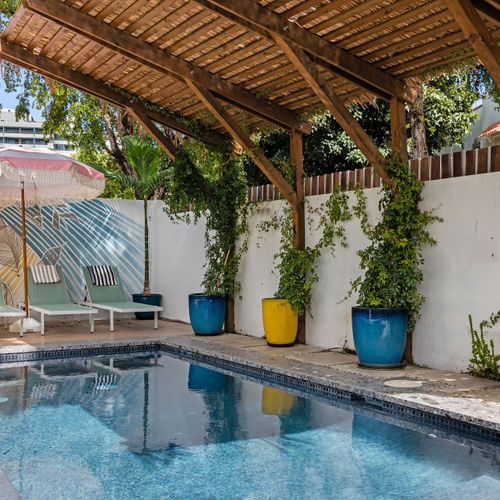 Take a refreshing dip in our pool under the clear sky.