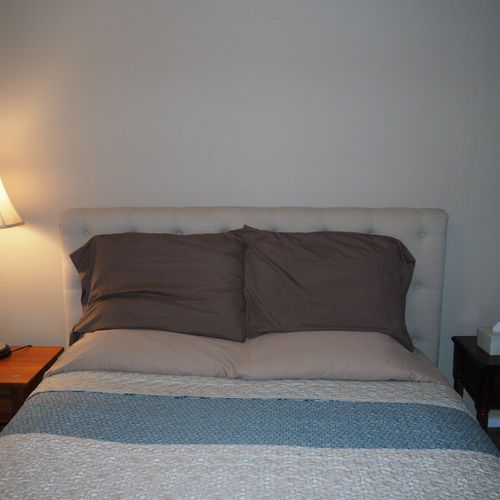 Bedroom #1:  features a queen-size bed, mirror, nightstands, lamps, dresser, chair, and television.