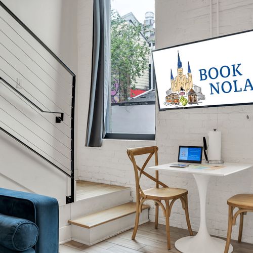 Wall-mounted smart TV & bistro-style desk setup bathed in natural light.
