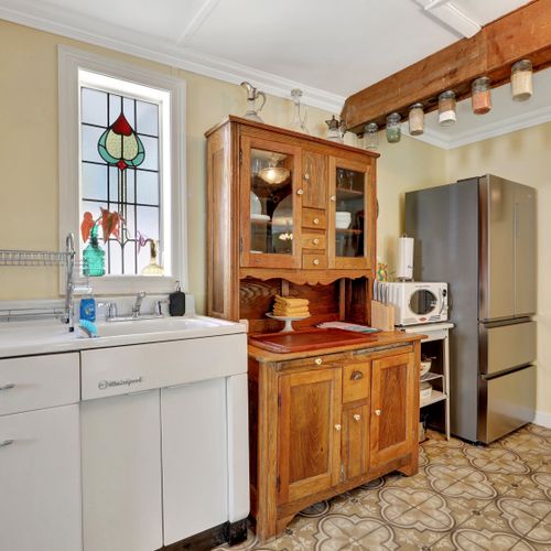 Rustic kitchen corner with wooden table and vintage touches.