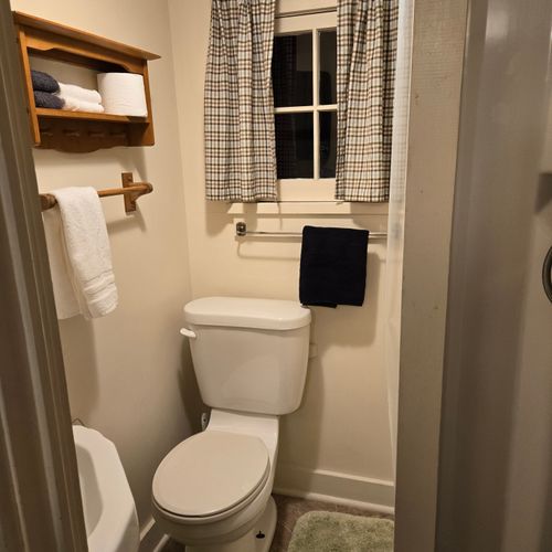 Bathroom:  there is a full bathroom with a shower, sink, vanity, mirror, and toilet.
