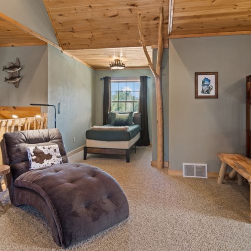 Loft:  features 2 twin-on-full bunk beds, twin bed, futon, television, and full bathroom.