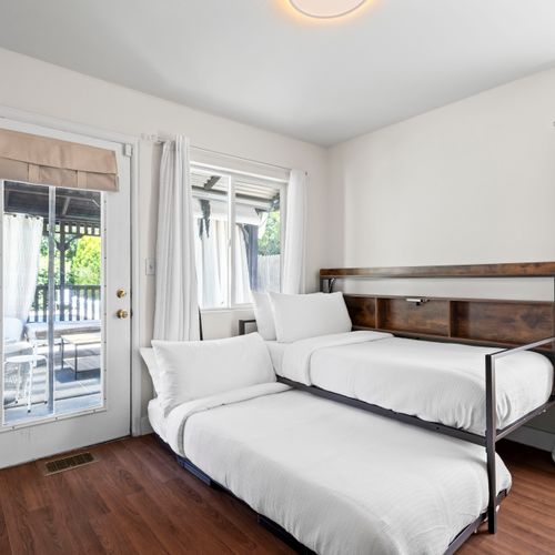 The third room features two plush beds designed for ultimate comfort.