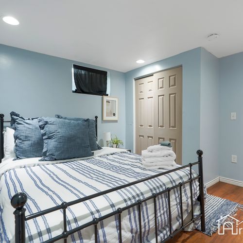 Get a good night's rest in this cozy downstairs bedroom, complete with a king-sized bed and plenty of natural light.