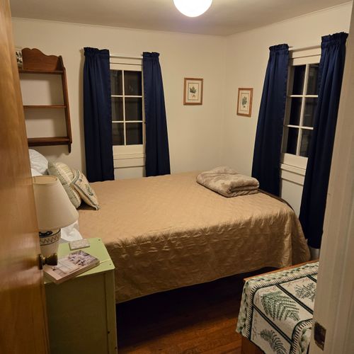 Bedroom #2:  features a full-size bed, nightstand, lamp, and dresser.