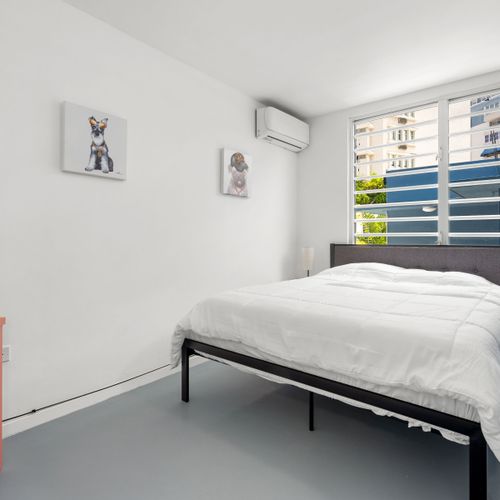 Find solace in this tranquil bedroom equipped with air conditioning for those warm days and nights - your cool oasis amidst the urban jungle.