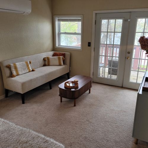 Bedroom #1:  the luxurious upstairs bedroom with an ensuite bathroom, a tv,  a closet, mini-split a/c unit, and private balcony
