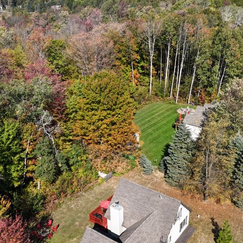 EXTERIOR:  Another aerial photo showing the house in the foreground and the ski slopes of Crystal Mountain in the background