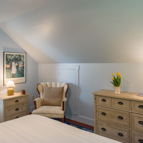 Our Impressionist guest room includes plenty of storage for unpacking and a sitting chair to dive into that book you packed!