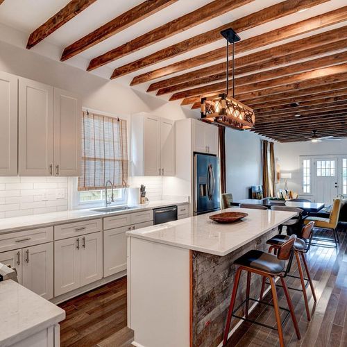 Sun-kissed kitchen w/ warm tones, open layout & everything you need to cook together.