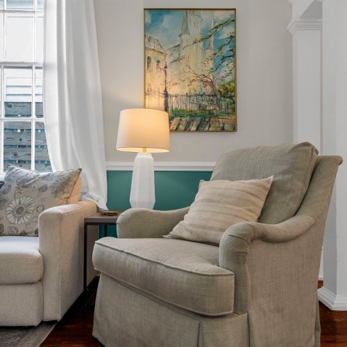 Cozy reading nook w/ a plush chair & soft natural light — perfect for quiet mornings.