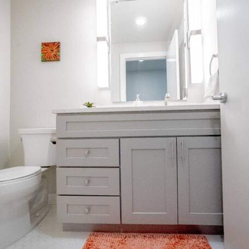 Tidy half bath w/ sink & toilet — conveniently appointed for guests.