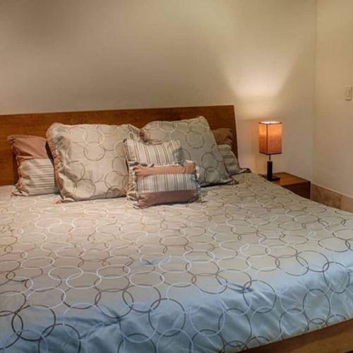 This second bedroom is furnished with a king bed.