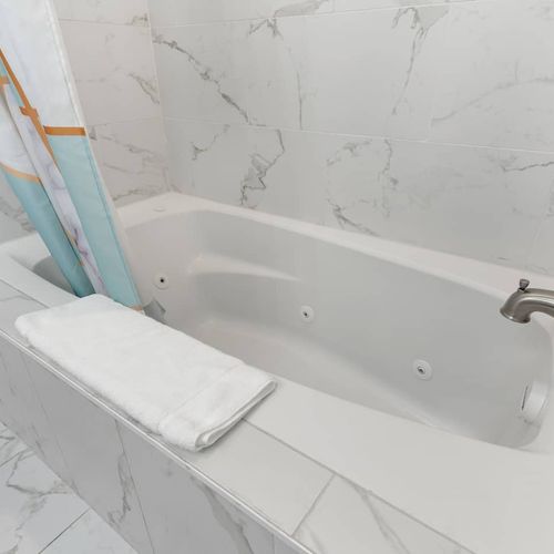 Soak and unwind in the bathtub found in the ensuite bathroom.