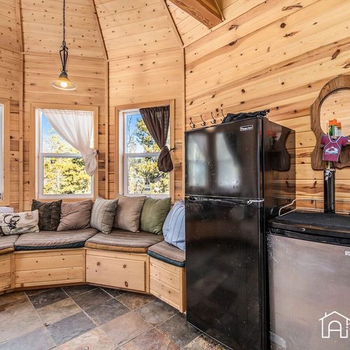 - compact fridge and freezer combo is perfect for snacks, drinks, and easy access
- curved seating nook invites morning coffee or afternoon storytelling sessions
- surrounded by tall windows, this sunlit space connects you with nature year round