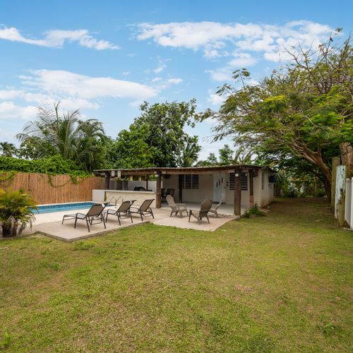 Enjoy the shade and fresh air by the pool.