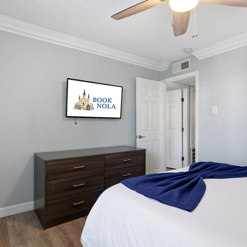 Peaceful bedroom w/ dark wood furniture & soft, soothing tones.