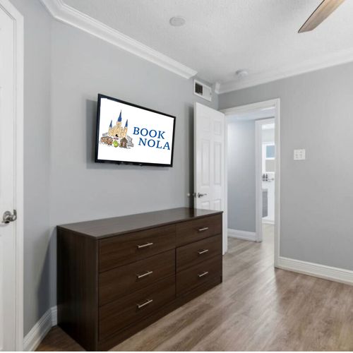 Cozy sleeping space w/ soft bedding & a wall-mounted TV for movie nights.