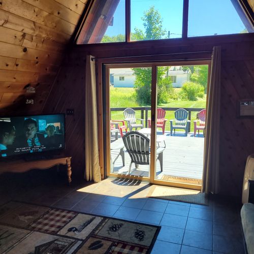 Living room:  features a sofa, futon, and a large television with cable television.