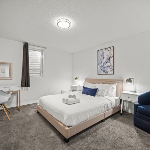 The second bedroom downstairs features a cozy queen bed and spacious closet. There's a dresser, luggage rack and plenty of shelving in the closet for your belongings.