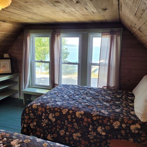 BEDROOM #4 (UPPER FLOOR):  Features two full-size beds, a dresser, closet, and a great view of Crystal Lake!