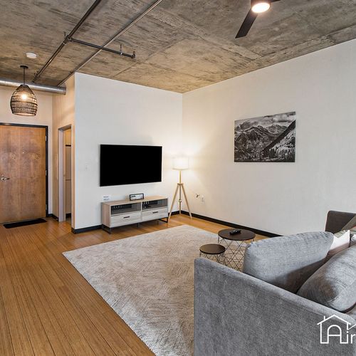 - stream your favorite shows on the mounted tv in this sleek and minimalist lounge
- soft lighting and a modern gray sofa create a clean and cozy atmosphere
- industrial ceiling details add urban edge to this relaxing retreat