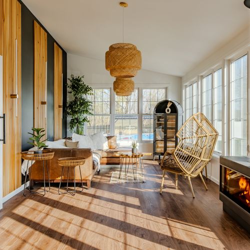 Step inside the home and be greeted by this warm, light-filled sun room. Please know the fireplace is currently non-operational!