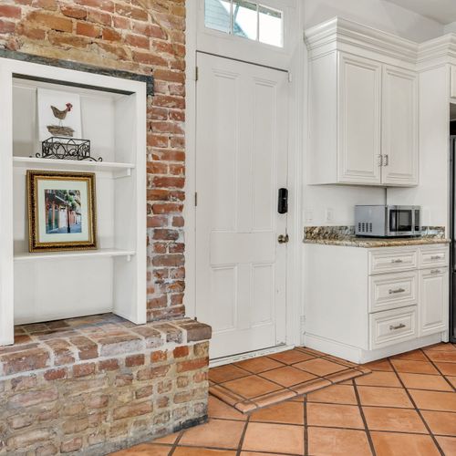 Exposed brick adds character to this elegant kitchen space.