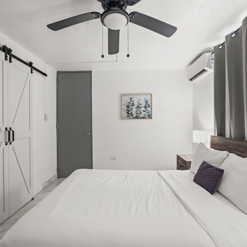 Spacious master bedroom with elegant wooden frame.