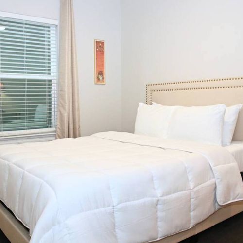 Rest easy in the third bedroom w/ a queen bed & crisp white linens.