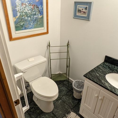 Bathroom #3 (first floor):  there is a third bathroom on the first floor. It's a half-bath with a toilet, mirror, vanity, and sink.
