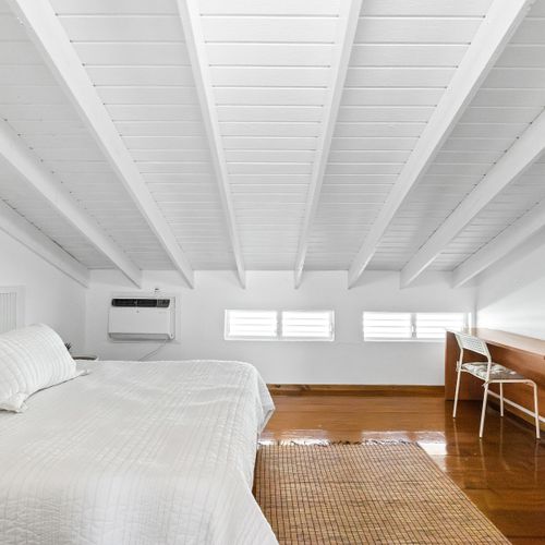 Stay productive with a dedicated work desk in this serene, air-conditioned bedroom retreat.