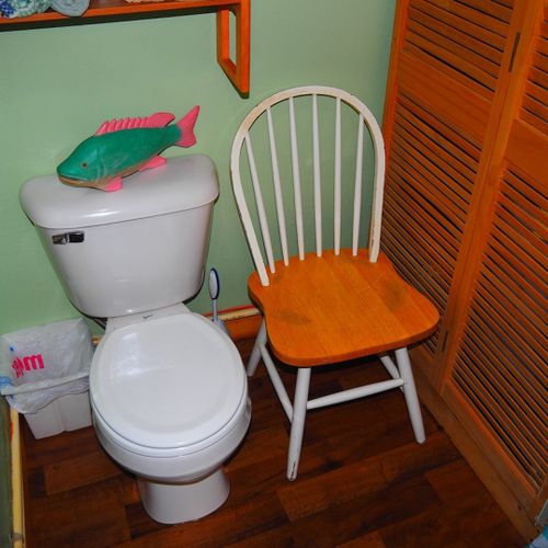 Bathroom:  very cute little bathroom with a sink, vanity, mirror, toilet, shower, and chair.