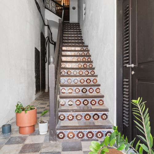 Upward style: Artistic stairs complemented by simple potted greenery.