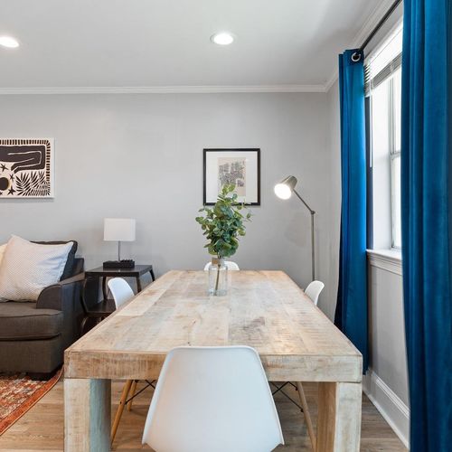Sunlit dining area w/ four seats — ideal for sharing meals together.