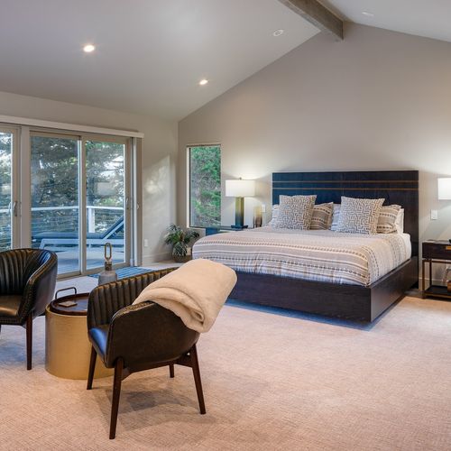 Amazing water views and a private balcony with sun loungers, fireplace and seating.