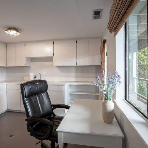 A small desk and chair in the laundry room for catching up on email.