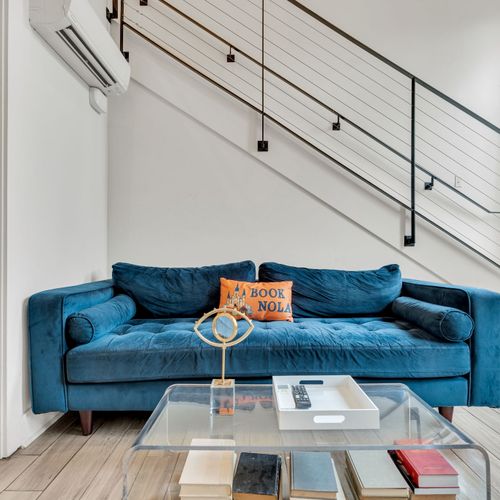 Bold blue sofa & modern accents create a stylish, cozy living space.